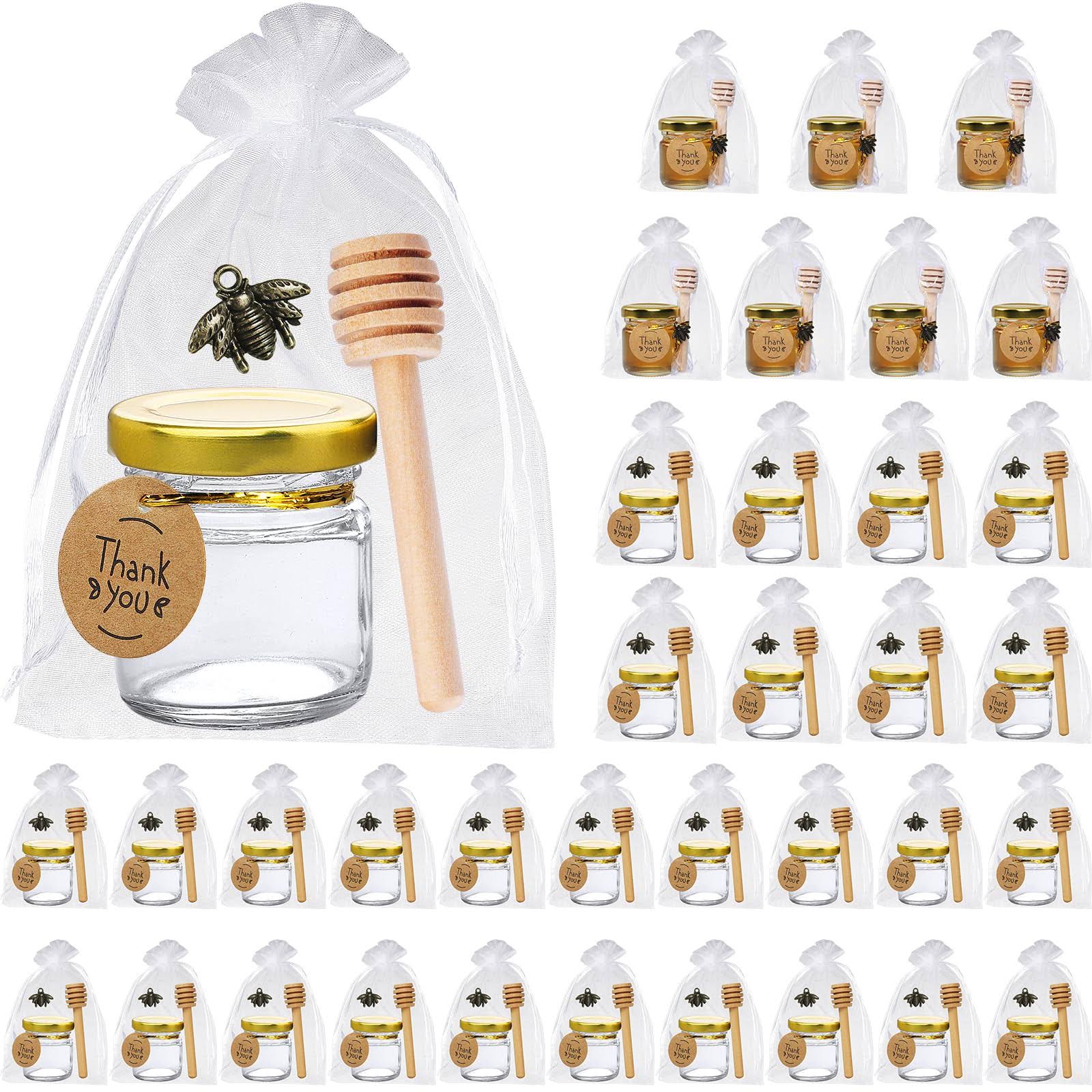 1b8dad4a4bfb7b45aabd8a9e5fd6e1006fd9d096b678ef4b735e64f72288537d.jpg 36 Pack 1.5 oz Mini Glass Honey Jars with Wood Dipper - Small Glass Favor Jars with Airtight Lids, Bee Pendant, Gift Bag, Gold Twist Tie and Tag - - Image 1