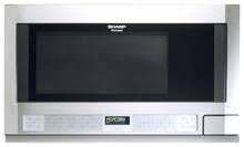 372e8d3098cdc8807fc1947a46f409ab0b4e36a9c81610d9e5c5be3016ac2b80.jpg Sharp R1214T 1.5 Cu. ft. Stainless Steel Over-the-Counter Microwave - Image 1