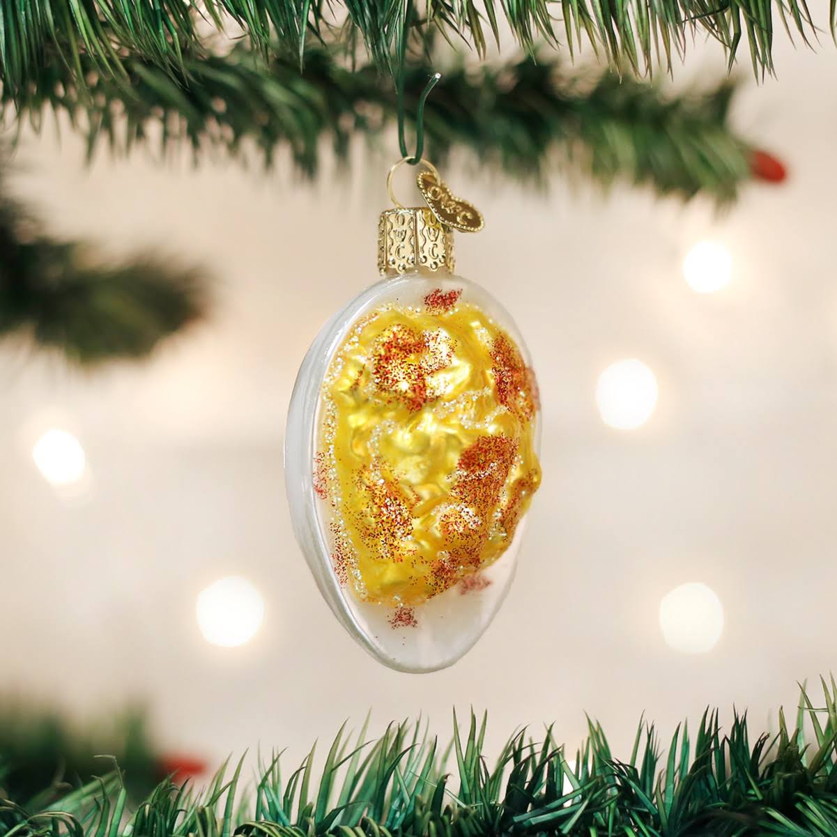 38ab3cd4b96155fc00996456f09608dad4ea76f9d2ca38c65391790387a2226a.jpg Old World Christmas Glass Ornament - Deviled Egg - Image 1
