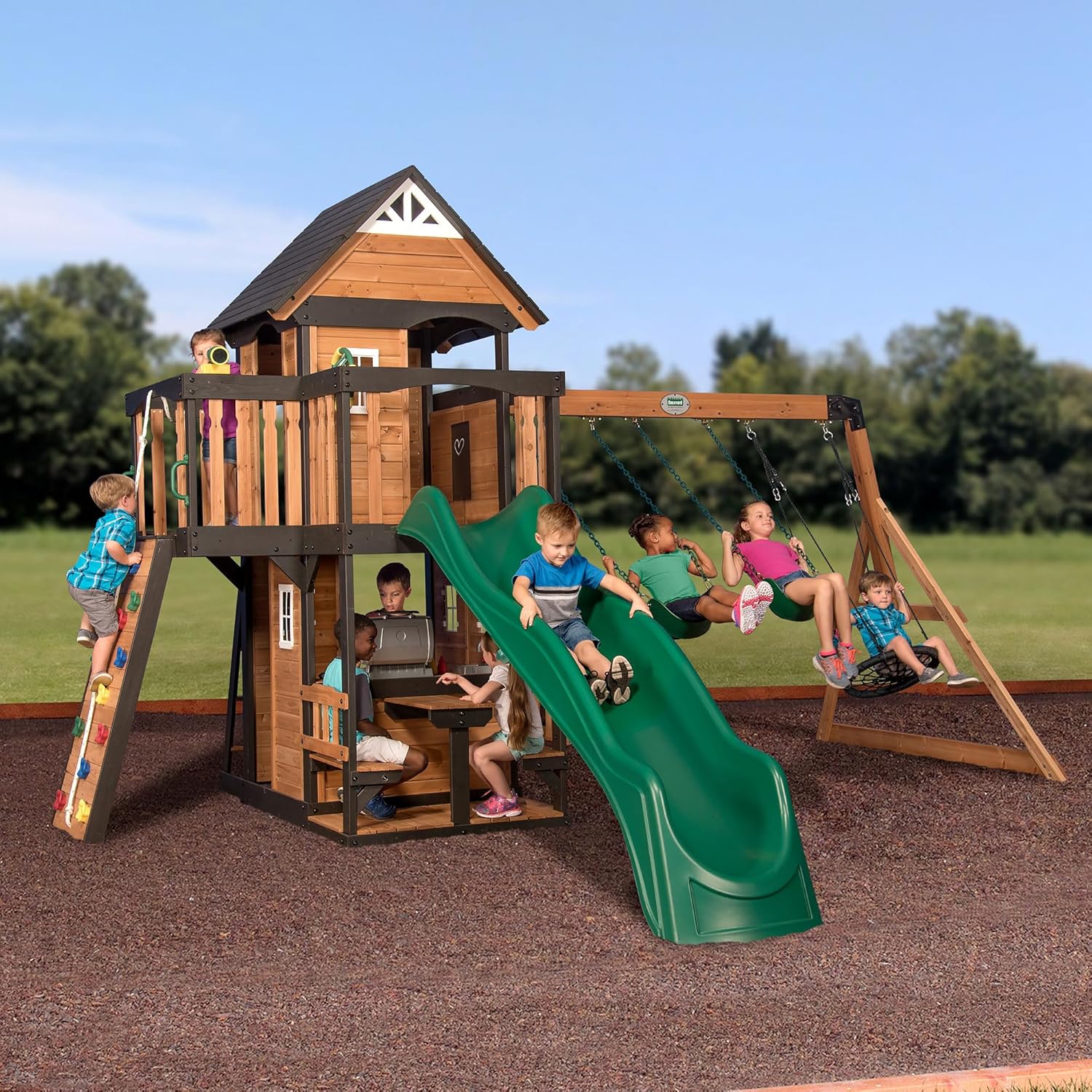 39488c5c38a834329c6a825d690849b3d6589bd973bd4528e28aa068fea9e2c9.jpg Canyon Creek Cedar Wood Swing Set with Wave Slide, Clubhouse, Play Kitchen, Picnic Area, Belt Swings, Web Swing, Rock Wall, Balconies, Playhouse, Step Ladder, Outdoor Playset - Image 1