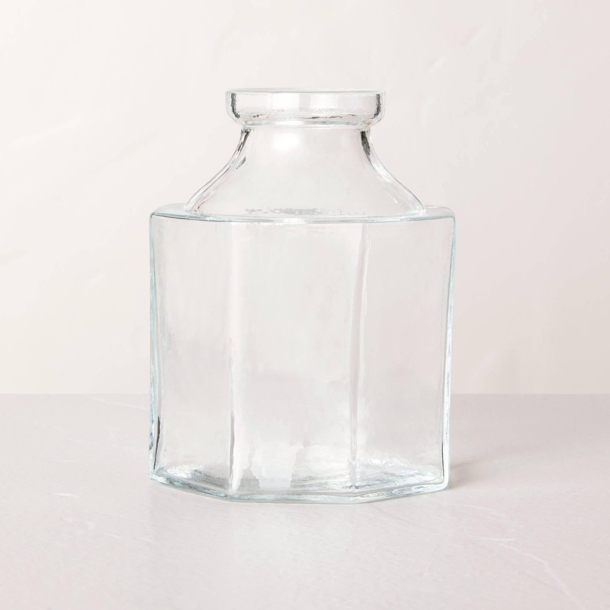 511cf6f81fb708cc5c33ba4613ace8e45ba36b0be82191dd75162582de21dab7.jpg Small Octagonal Clear Glass Bottle Vase - Hearth & Hand with Magnolia - Image 1