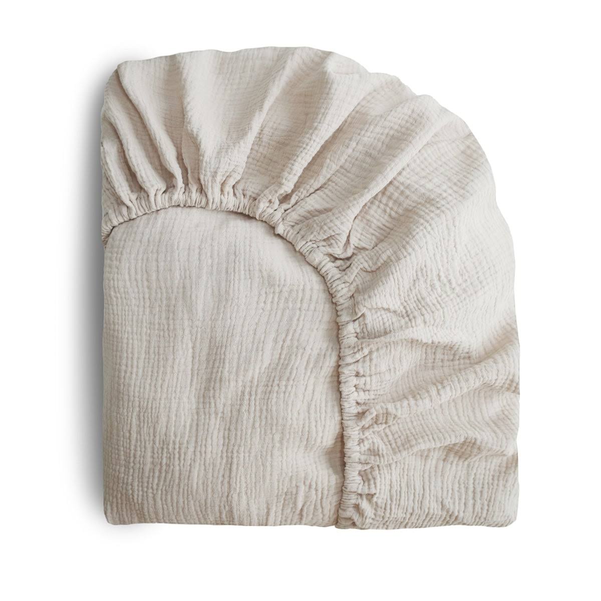 5352cad95a4b861dfa3fc74e8d48165761397ae474c3cffd851e6ba142bcb1c5.jpg Mushie Extra Soft Muslin Crib Sheet (Fog) - Image 1