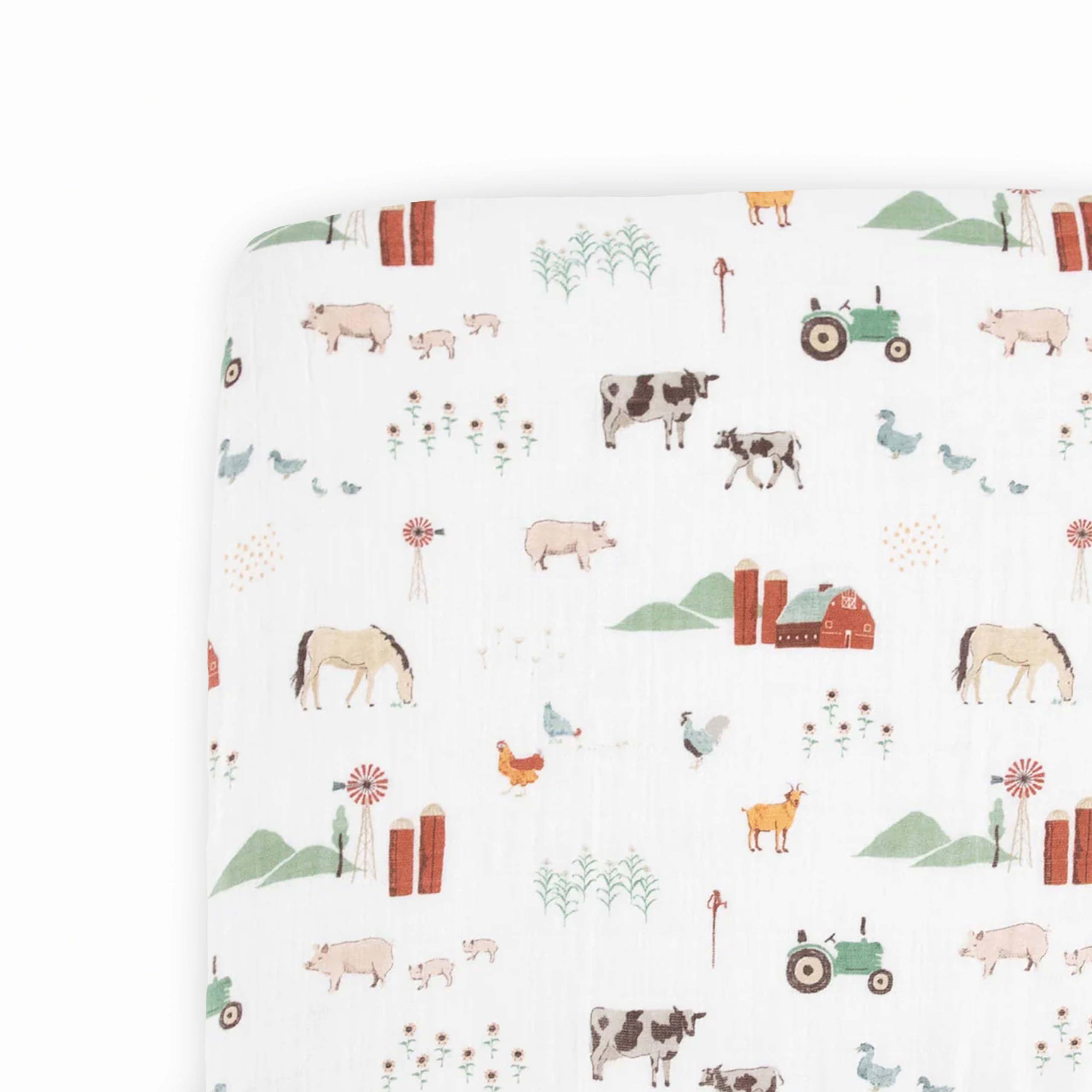 7f0c7d8ff034b71d890883caee6c46a98ef4b4ab57e128dc7a0f7fcc192974f3.jpg Little Unicorn Cotton Muslin Crib Sheet - Farmyard - Image 1