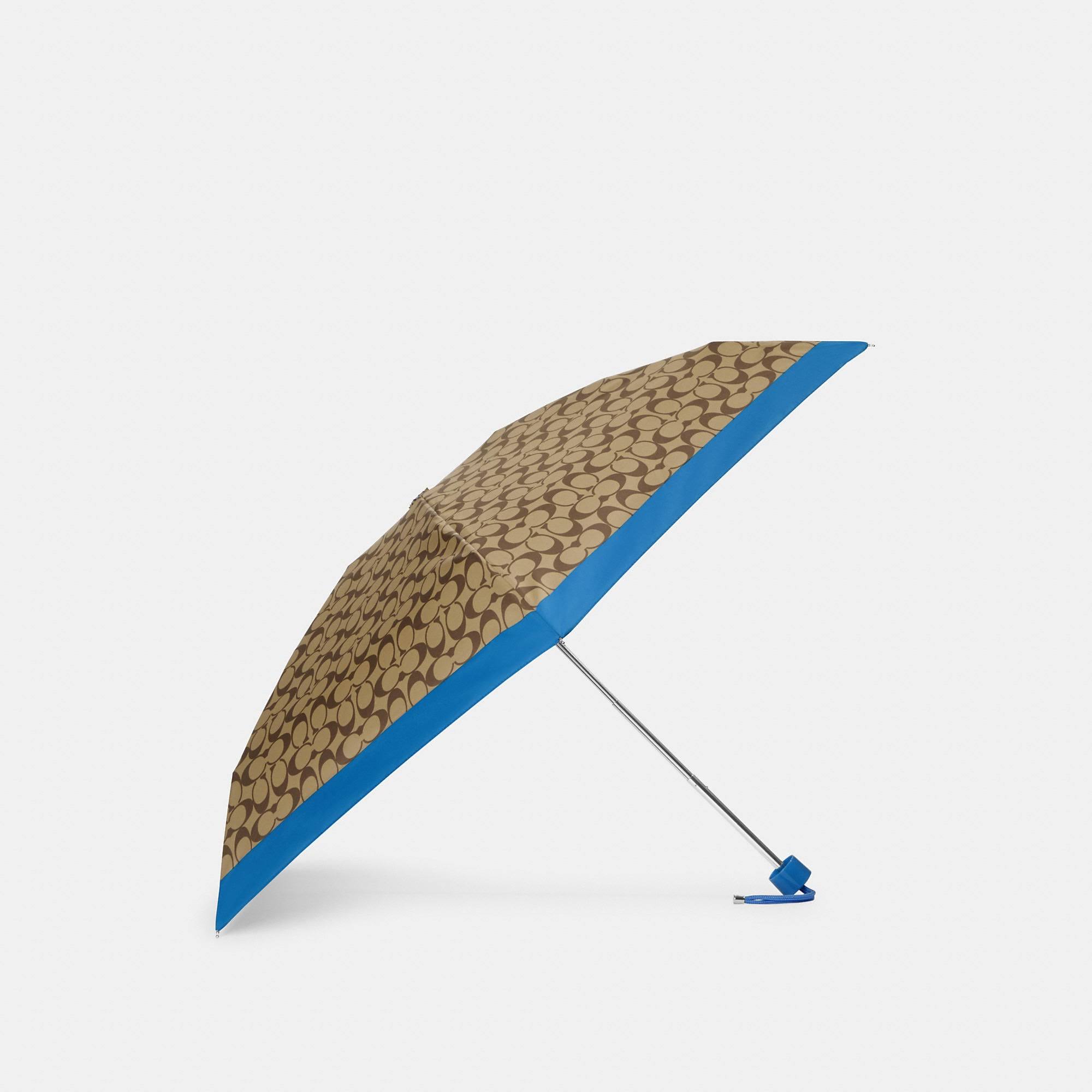 886c4183e50977e20ce047e474371d74be2689af6b89dd28ac7a49b4475b5195.jpg Coach Outlet Mini Umbrella in Signature - Blue - Image 1