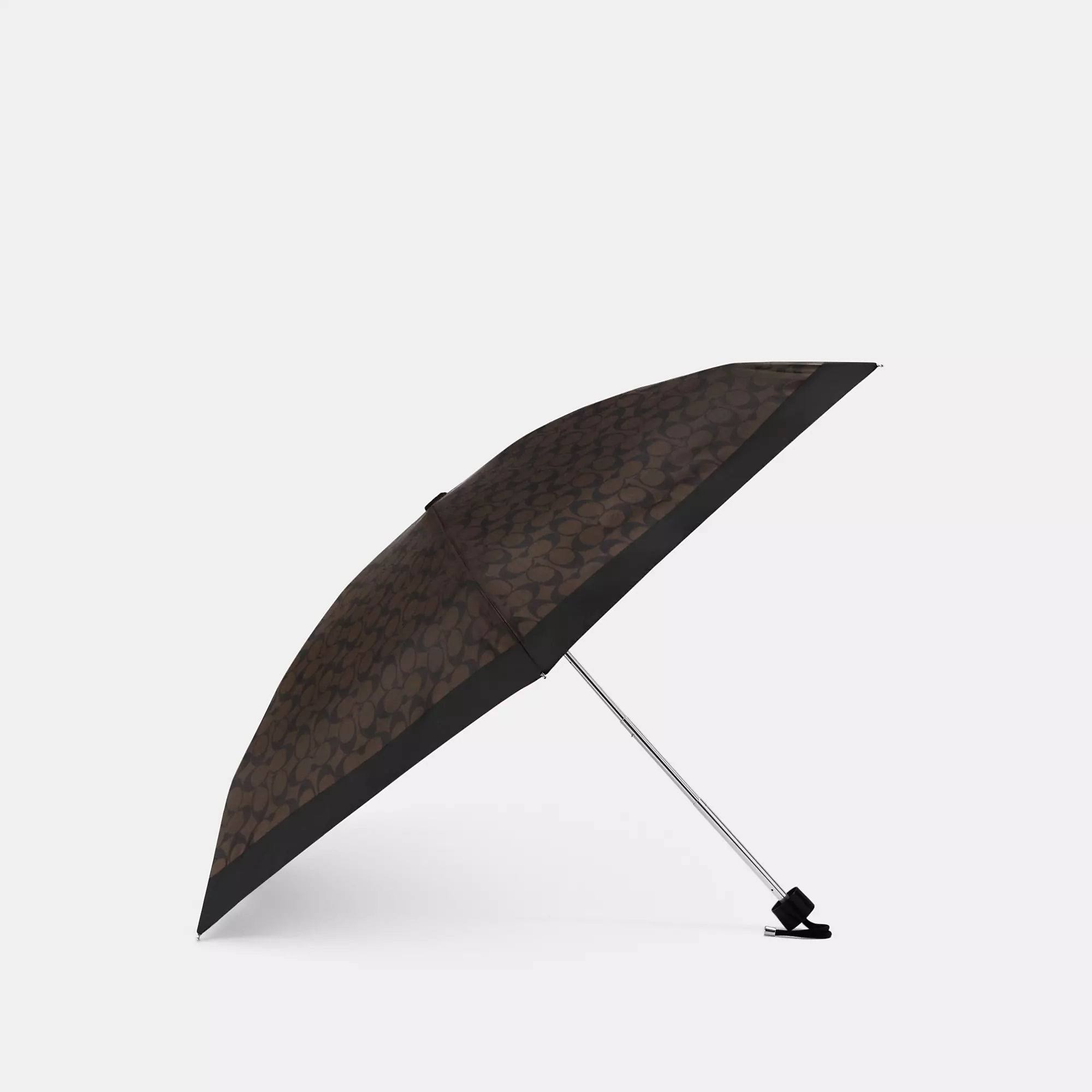d084efbc9e13f5c60b97bbe58e09186ff5a42e24cf75e8d78b8880fb19e10305.jpg Coach Outlet UV Protection Signature Mini Umbrella - Gold/Brown Black - Image 1