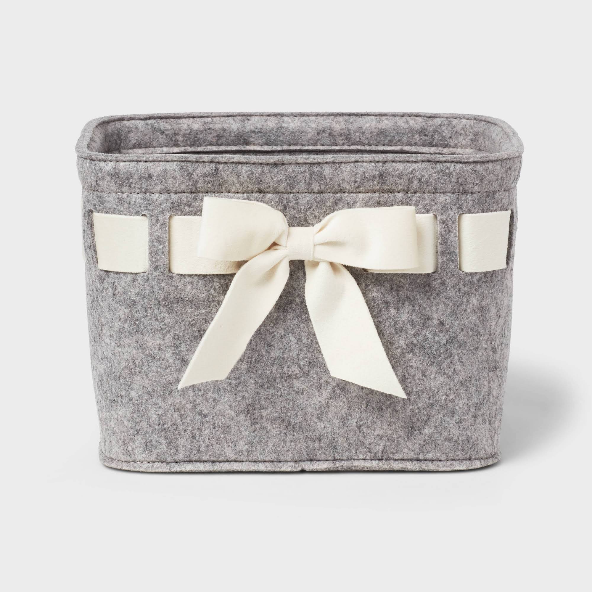 d44906e783030da6b438524204b3296991fb80ebcca092edc8193cb9cab1035a.jpg Threshold Felt Gray Basket with Ivory Velvet Ribbon | Target - Image 1