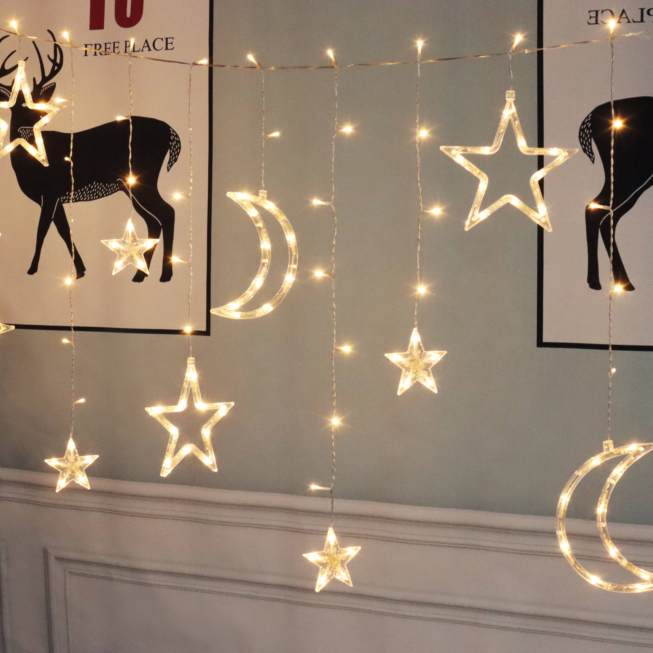 dac22ce125a4c1cc77fcf4e05bfa2f79ded7a7c67ee753a5a9c0b2beed3a8cbe.jpg Mainstays 144-Count Indoor Battery Operated Warm White LED Curtain Lights with Stars and Moons - Image 1