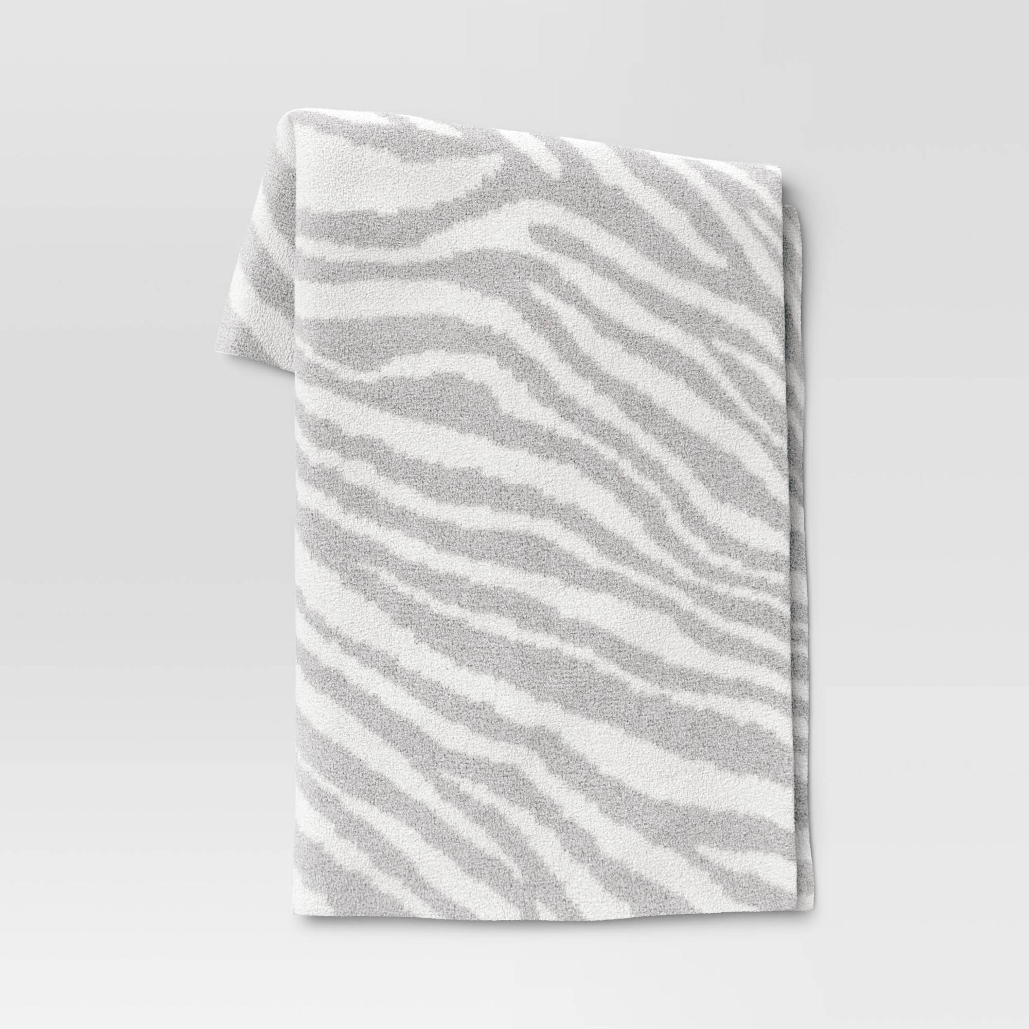 f8248b17fb4192ee53a5daa9fc89b4fb8e83a6af9d4eb6a2bbaf6b0a53e050ba.jpg Cozy Feathery Knit Zebra Throw Blanket Gray - Threshold - Image 1